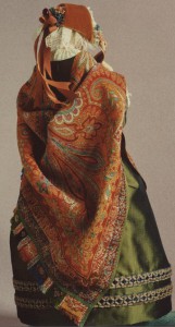 An imaginary figure from the Victorian age with paisley shawl and silk gown, fastens the strings of her velvet bonnet before going for a walk. Note her gloves, sculpted onto her delicate hands. Emma Rose
