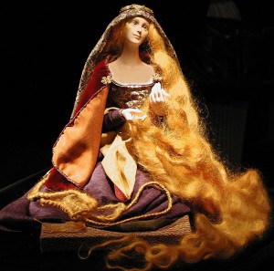 Rapunzel is covered in rich silks, from her kirtle to her brocade bodice, as she waits in the tower for a prince to save her. The hair played a major part in this commissioned piece—half ultimately housed in a basket, the other half braided. Rapunzel